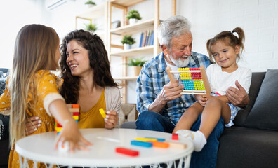 Wall Mural - Happy family having fun time at home. Grandparent playing with children