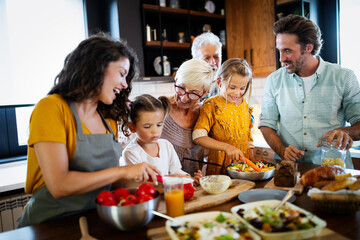 Wall Mural - portrait of happy family in kitchen at home