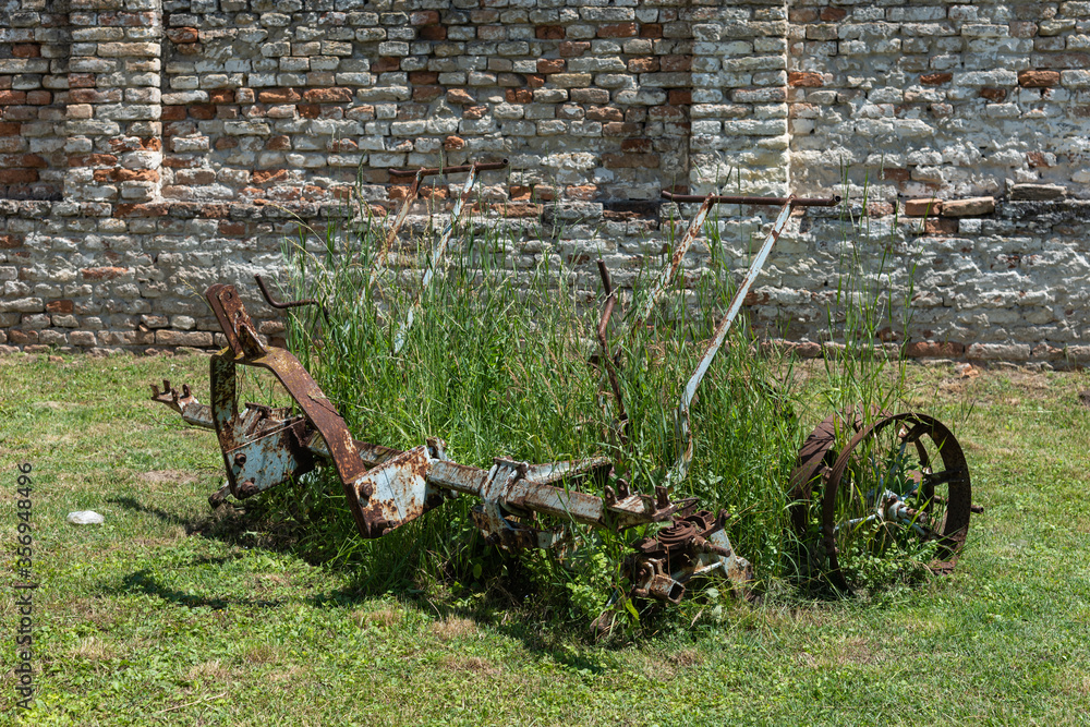 Old Forgotten Plow. An old machine used for harrowing, old and rusty