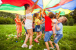 © oksix - Happy kids under colorful canopy. Summer camp activities