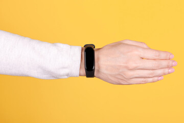 Canvas Print - Black smart fintess band on hand.