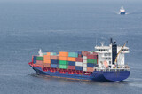 Fototapeta  - CONTAINER SHIP - Merchant vessel sails through the port channel on a sea voyage
