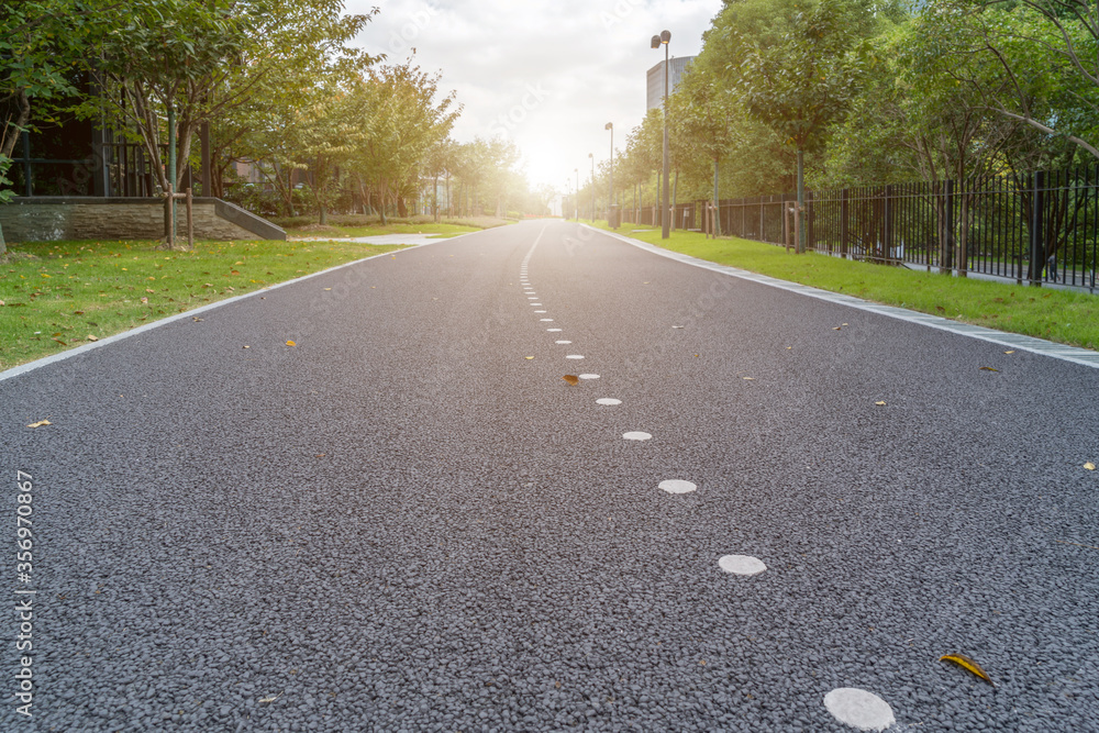 Asphalt road and park green forest landscape Stock Photo | Adobe Stock