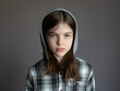 © polya_olya - Portrait of a young serious girl in a hoodie on a dark background