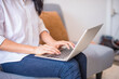 © Panya Studio - Woman hands typing on laptop keyboard at the home, Woman worker and business concept.