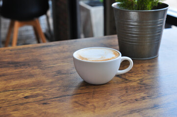 Wall Mural - cup of coffee  on wooden table