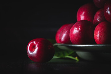 Wall Mural - Dark red cherries on a pewter plate