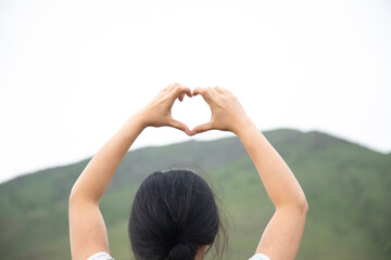 Poster - woman hand heart sign in  mountain