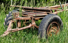 Old Rusty Trailer Standing Abandoned In An Overgrown Meadow