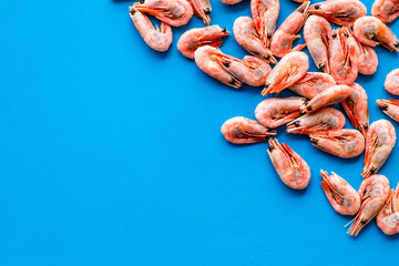 Shrimps background on blue table top view frame copy space