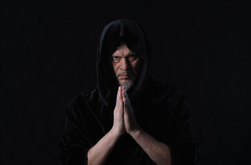 Sticker - portrait of a medieval monk with a hood on a black background