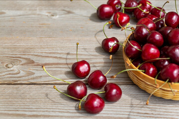 Appetizing ripe cherry on a wooden table. Close-up.