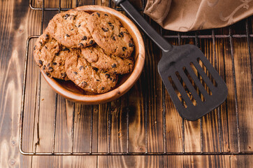 fresh homemade cookies in a wooden plate/cooked homemade cookies in a wooden plate. Top view.