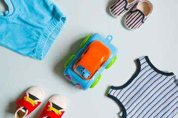 Wall Mural - Kit of baby boy's goods. Infant clothes, tiny shoes and toy on blue background.