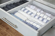 Open drawer with folded towels. Order in kitchen