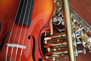 Closeup detail of classical musical instruments; violin, trumpet and clarinet 