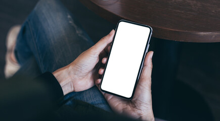 cell phone mockup image blank white screen.woman hand holding texting using mobile on desk at coffee shop.background empty space for advertise.work people contact marketing business,technology