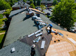 © ungvar - Construction worker on renovation roof the house installed new shingles
