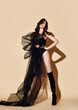 © Dmitry Lobanov - Gorgeous brunette woman is posing in provocative sexy black wedding dress transparent cloth and high boots
