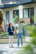 © zinkevych - Tall man in jeans pointing to the house and talking to the well-dressed woman