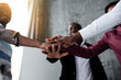© DmitryStock - Bottom view of black colleagues who joined hands for hard team work against racism among countries of the world.