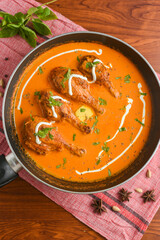 Wall Mural - Murgh Makhani, Butter chicken Tikka Masala curry and Chapati, hot and spicy gravy meat dish Delhi India, served with Roti, Paratha, rice. Top view of North Indian non veg food on dark background.