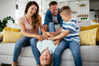 © JustLife - Young family enjoying at home Happy parents with sons having fun.