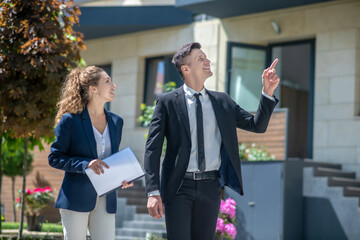 Client in a black suit and a broker discussing details of the deal