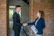 © zinkevych - Male investor in a black suit shaking hands with the broker