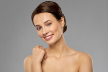 Beauty, Bodycare And People Concept - Beautiful Young Woman With Bare Shoulder Over Grey Background
