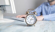 © andranik123 - Alarm clock on the desk. Businessman working in office