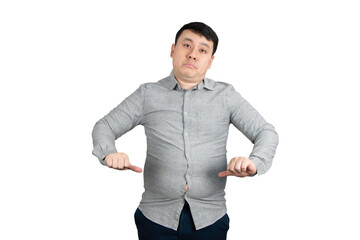 Unhappy young overweight man with a big belly show thumb down isolated on white background.	
