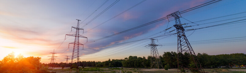 Wall Mural - industrial background of silhouette of transmission tower, electricity pylon on red sunset backgroun