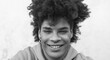 © Alessandro Biascioli - Afro smiling man portrait - Mixed race young guy with curly hair posing in front camera - Youth millennial generation culture and multi ethnic people concept - Black and white editing