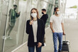 © Olha - Figures of young people in protective masks near the airport. Safe travel during a pandemic. Airplane travel, quarantine and pandemic concept