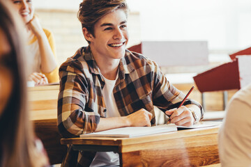 Teenage boy smiling during lecture in high school