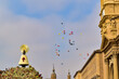Children's balloons flying free over the Virgen del Pilar full of flowers on the day of the flower offering in Saragossa