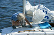 © Yurii Zushchyk - Yachtsman setting sail of a yacht before race