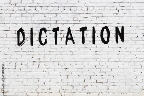 Fotografía Word dictation painted on white brick wall
