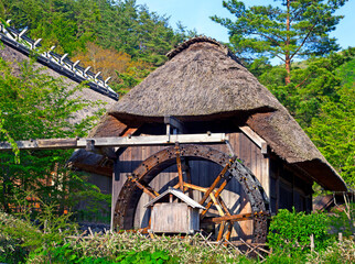 Wall Mural - A traditional water mill in the samurai village of Saiko Iyashi no Sato Nemba in Japan.