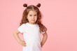 © oes - Portrait of cute european little toddler girl over pink background. Looking at camera. Child model in white T-shirt. Advertising childrens products