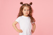 © oes - Portrait of cute european little toddler girl over pink background. Looking at camera. Child model in white T-shirt. Advertising childrens products