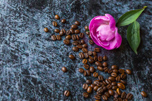 
A Flower Next To A Handful Of Coffee Beans On A Vintage Background With Meta For Text.