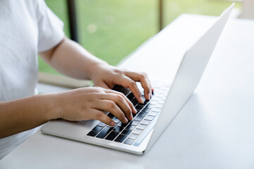 Manager working on a project in open space office. Laptop on wooden