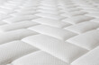 © Evrymmnt - Close up shot of white orthopedic mattress top side surface pattern with a lot of copy space for text. Hypoallergenic foam matress for proper spinal alingment and pressure point relief. Background.