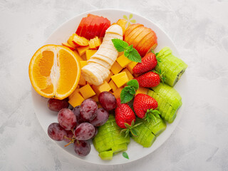 Wall Mural - Closeup plate with assorted fruits and berries for fruit salad top view