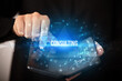 © ra2 studio - Businessman holding a foldable smartphone with CONSULTING inscription, business concept