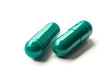 green pills on white background