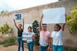 © Hector Pertuz - A group of multi-ethnic people marching and holding banners in a protest. Demonstration for the closure and unemployment. Space for copy