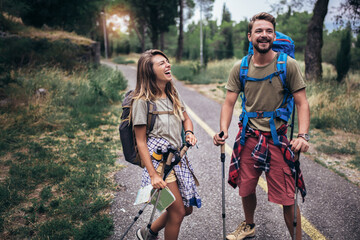 romantic couple hiking on the path in mountains